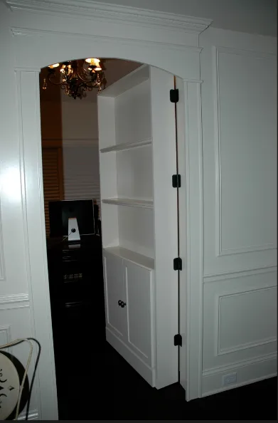 White panelled bookcase door with concealed hinges in an elegant interior